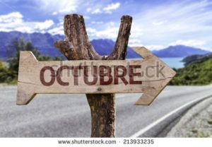 stock-photo-octubre-in-spanish-october-wooden-sign-with-a-street-background-213933235